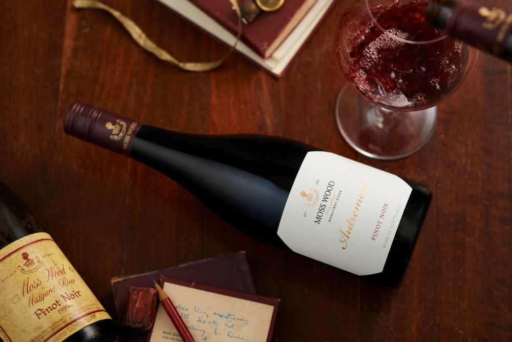 Flat image of Autrement pinot noir, with wine pouring into a glass